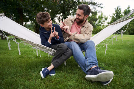 Cheerful father and son having fun outdoorsの写真素材