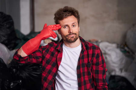 Man pointing fingers to head as if he about shoot himselfの写真素材
