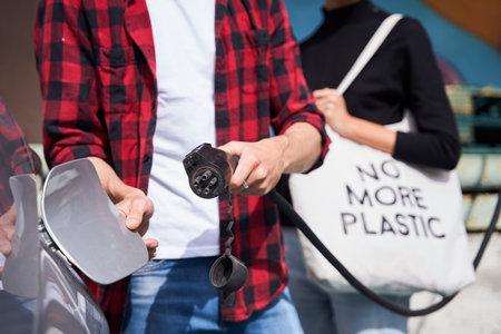 Caucasian man charging electrocarの写真素材