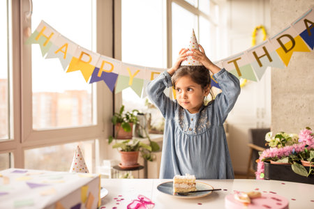Girl looking away and straightens the cap on her head while eating