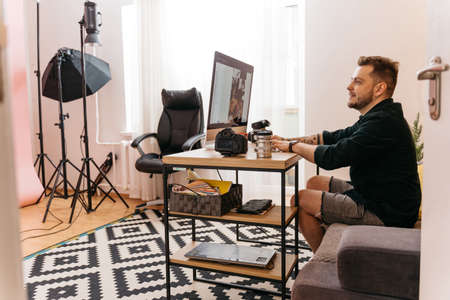 Photographer is working at the computer while retouching photosの写真素材