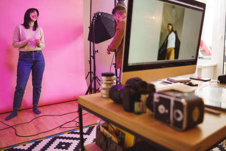 Model laughing out loud while standing at the studio and posingの写真素材