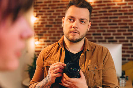 Photographer listening to the wishes of his model while having sessionの写真素材