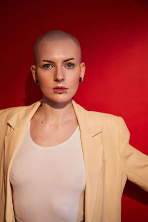 Female standing and looking at the camera while posing at the fashionable clothesの写真素材