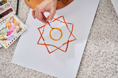 Female artist creating her new picture at the weekend