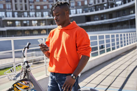 Delivery food courier guy checking order via mobile phone
