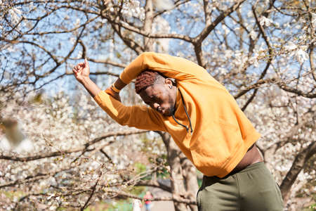 Man warming up before a morning workout at the spring park at the morningの写真素材