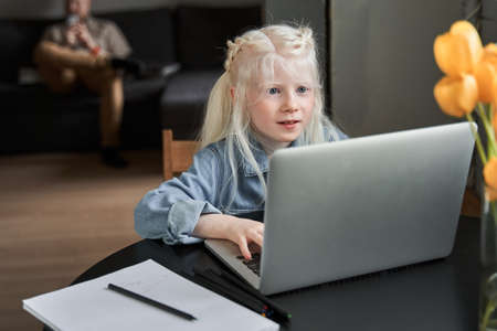 Girl stuck with hard task, preparing homework at home at the self isolationの写真素材