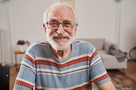 Man wearing glasses sharing positive emotions while posing to the camera