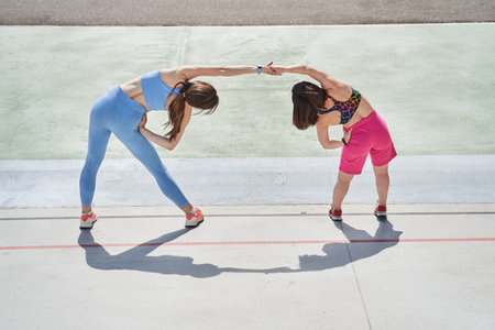 Girls training at fresh air at morning with concentrated emotions while making slopes