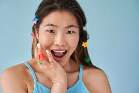 Asian woman with cute hairstyle open her mouth and looking at the camera