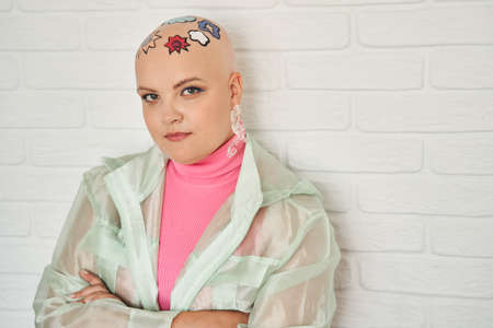 Woman with patterns at head standing arms crossed and looking confidently to the camera