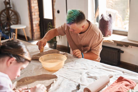 Boy wiping future plate with a wet sponge and feeling concentratedの写真素材