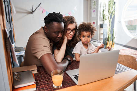 Girl emotionally looking at laptop screen and feeling surprised while watching cartoons