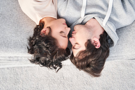 Woman laying at the floor and bonding to her boyfriend with pleasure