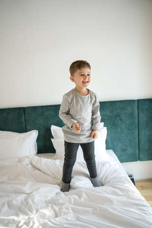 Boy having good time in the bedroomの写真素材