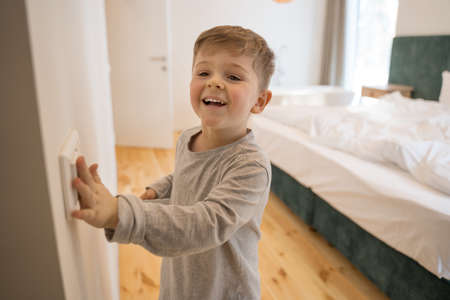 Boy playing at game at the bedroomの写真素材