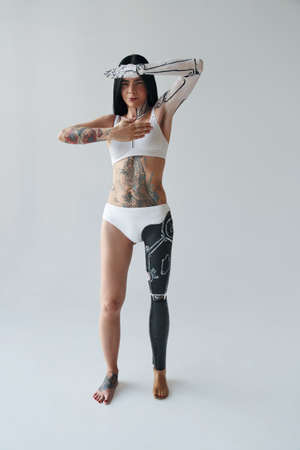 Full length view of the tattooed girl in body makeup, fashion sci-fi body art style for robot cyborg technology. Studio shot. Stock photoの写真素材