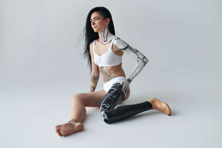 Futuristic creative avant-garde cyber body art at the girl with artificial legの写真素材