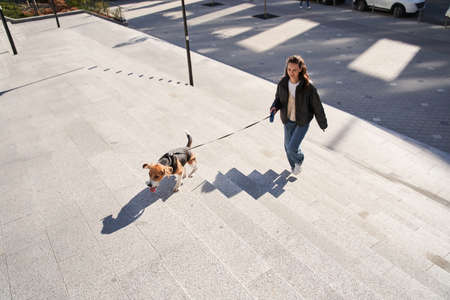 Girl catching up with the beagle
