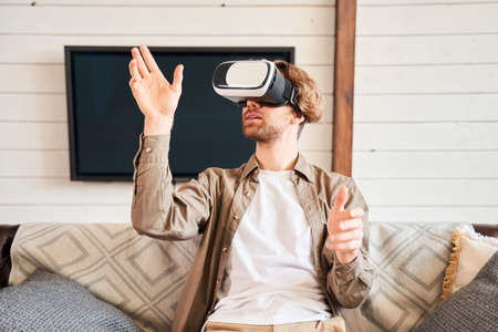 Man getting new experience while using VR-headset