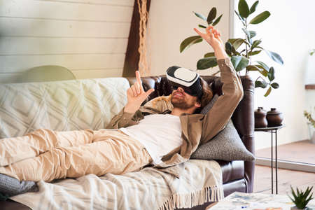 Man adjusting his VR headsetの写真素材