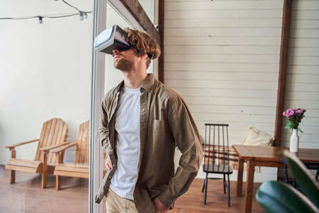 Man in VR headset standing at the living room