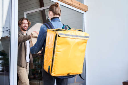 Man received food parcel with his orderの写真素材