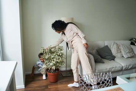 Boy playing at the peekaboo with his lovely mother at their apartmentsの写真素材
