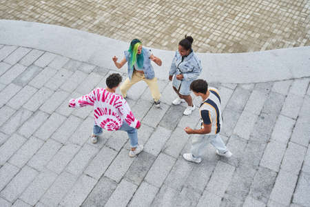 Four best friends preparing trendy dance for social networksの写真素材