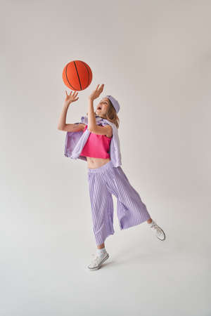 Little girl catching or throwing basketball ballの写真素材