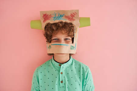 European boy head in painted paper bag with cupsの写真素材