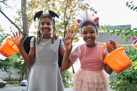 Girls are gesticulating like spookes at halloweenの写真素材