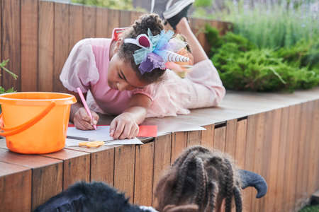 Little black girls crafting something at halloweenの写真素材