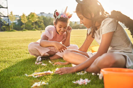 Little black girls looking at halloween treatsの写真素材