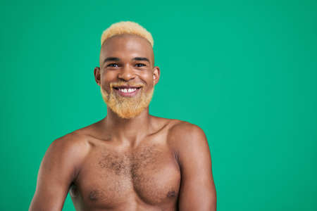 Multiracial man with blonde hair looking directly at the camera and smilingの写真素材