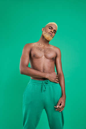 Blonde multiracial man looking at the camera and feeling confident while posingの写真素材