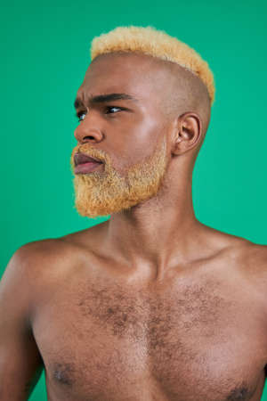 Portrait of naked strong multiracial guy posing at studioの写真素材
