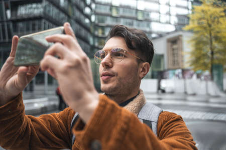 Man shooting buildings and views while traveling at the new cityの写真素材