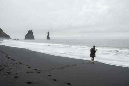Man shooting at his smartphone perfect view of famous powerful oceanの写真素材