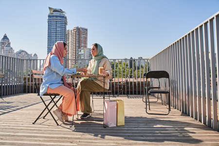 Islamic women wearing headscarfs chatting with each other