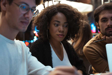 People looking at the tablet computer while solving business problems during the eveningの写真素材