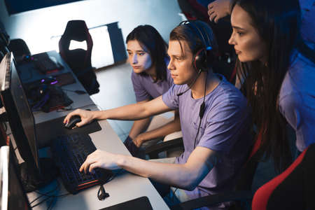 Professional boys and girls gamers actively thinking and discussing game strategy tacticの写真素材