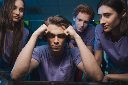 Geek wearing headset losing at the first-person shooter and feeling upsetの写真素材