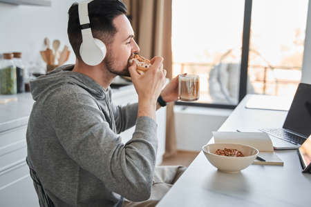 Confident freelancer happy about tasty breakfast during the successful work from home