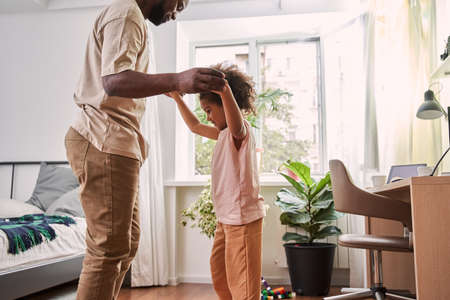 Happy father is holding hands with his little daughterの写真素材