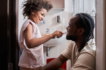 Young biracial male performing morning face care routineの写真素材