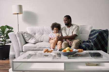 Multiracial family of single father and child daughter bonding, embracing and playingの写真素材