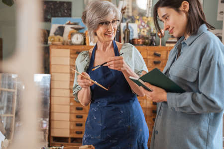 Woman student holding notebook and feeling happy of the new knowledgesの写真素材