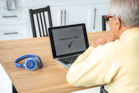 Grey haired man received vaccination certificate while using special site